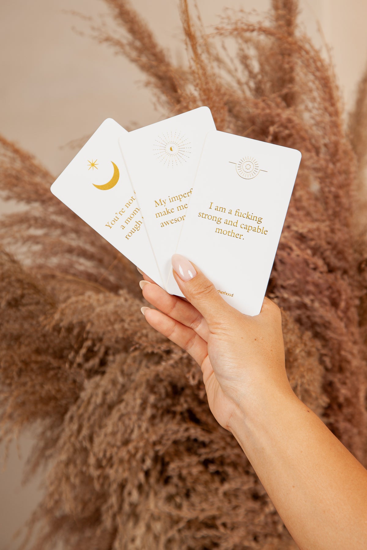 Gold-foiled badass motherhood cards with bold language